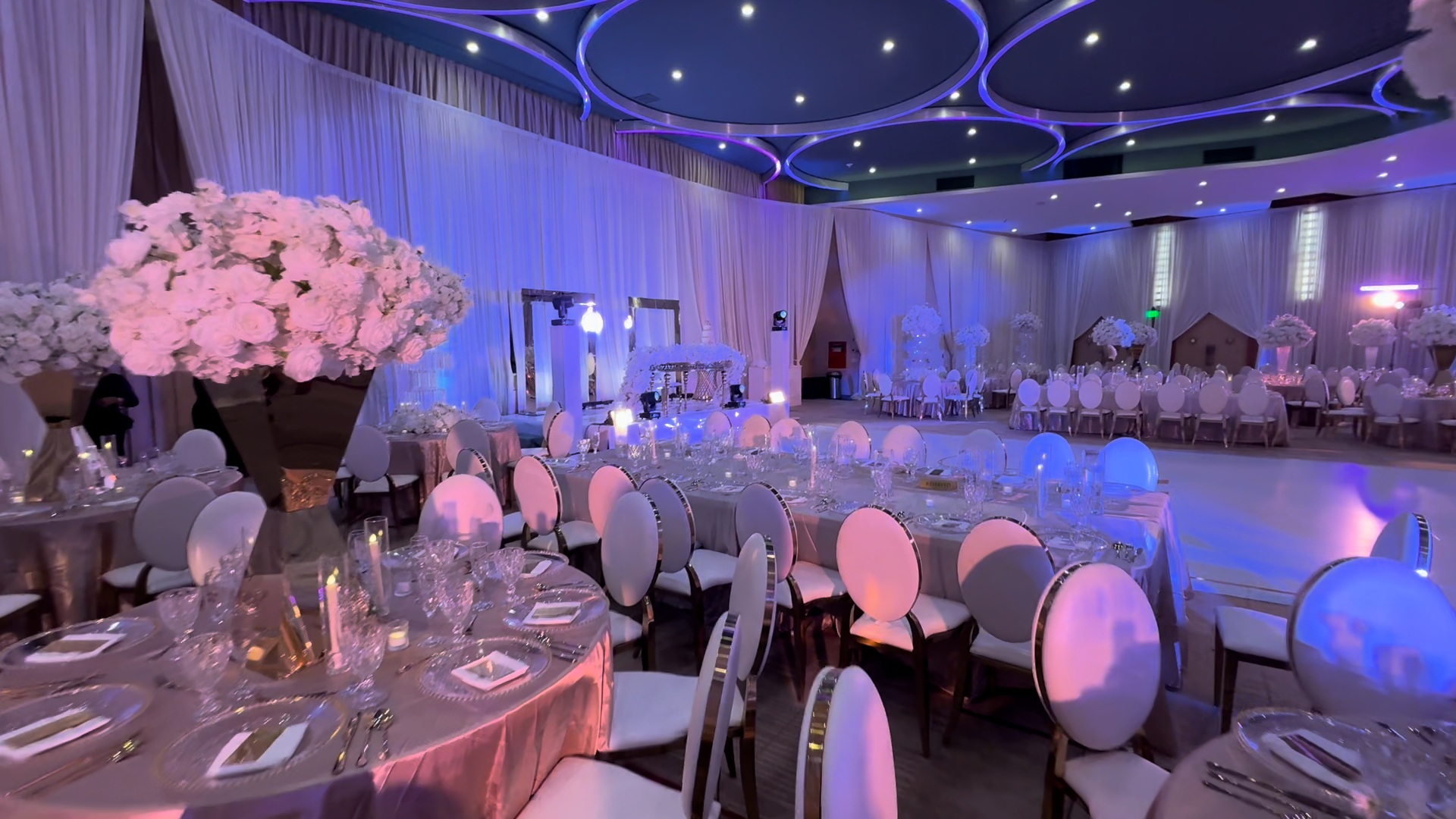 Draping and raised stage across a large wedding ballroom