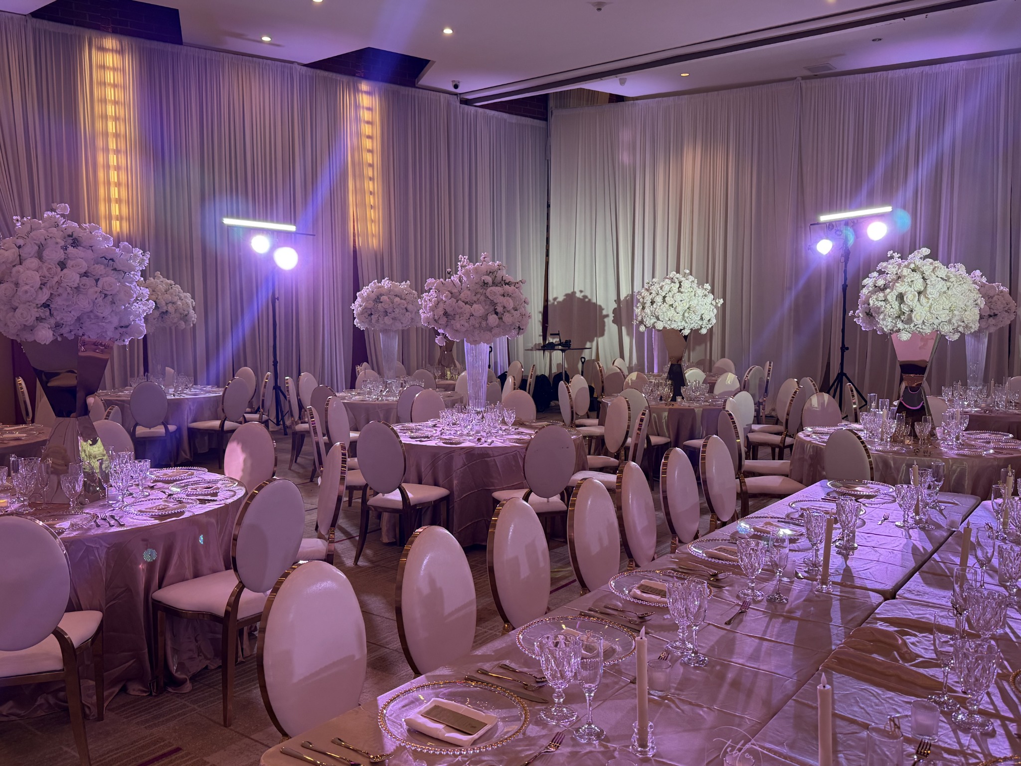 Illuminated floral centerpieces, candles, and architectural lighting
